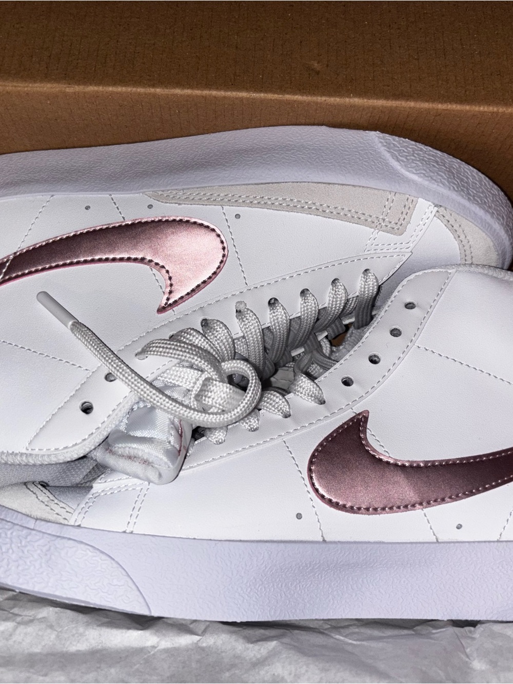 Nike Womenโs White Sneakers with Metallic Rose Swoosh